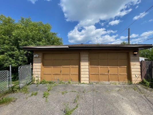 Two-car garage with wooden doors.