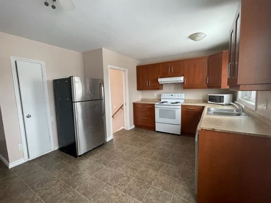 Modern kitchen with appliances and wooden cabinets.