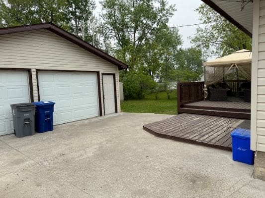 Driveway with garage and deck area.