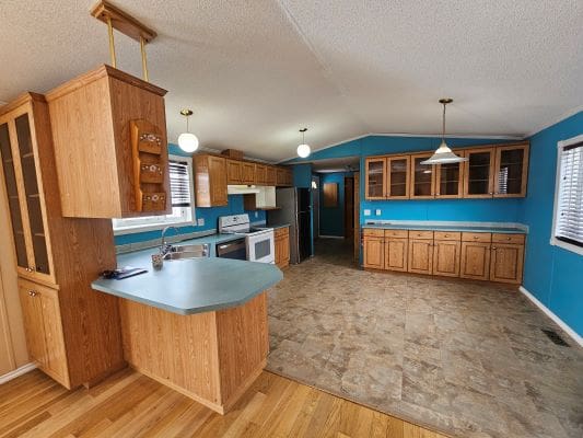 Spacious kitchen with blue walls and cabinets.