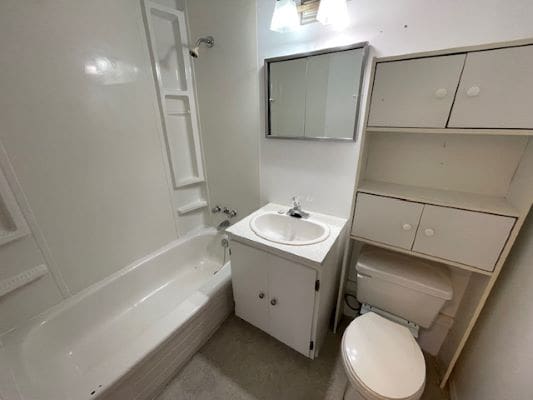 Compact white bathroom with sink and bathtub.