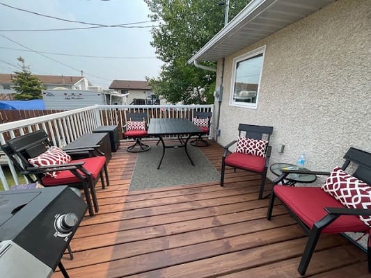 Wooden deck with seating and dining table.
