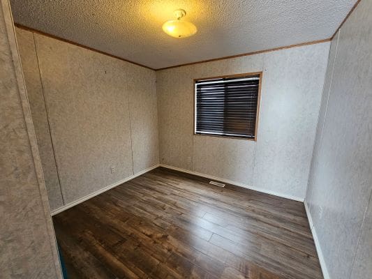 Empty room with wooden floor and window.