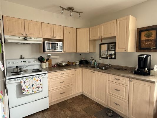 Modern kitchen with light wood cabinets.