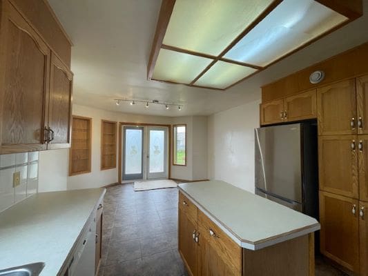 Spacious kitchen with wooden cabinets and island.