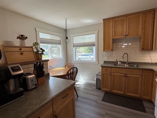 Cozy kitchen with wooden cabinets and table.