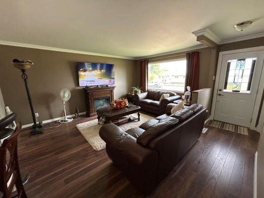 Cozy living room with brown leather sofas.