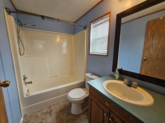 Small bathroom with shower and sink.
