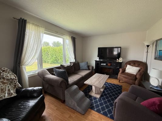 Cozy living room with large window view.