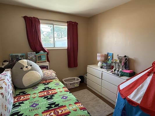 Colorful children's bedroom with stuffed animal.