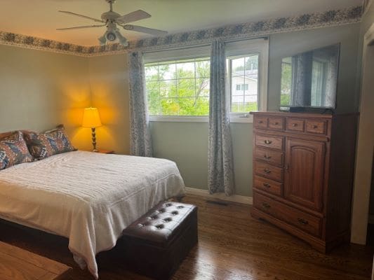 Cozy bedroom with bed and wooden furniture.
