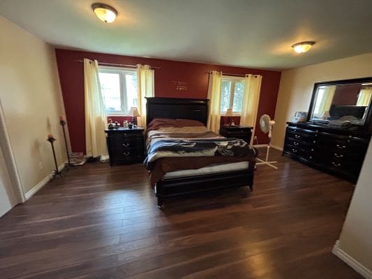 Cozy bedroom with wooden furniture and decor.