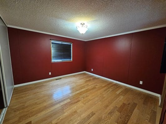 Empty room with red walls and window.