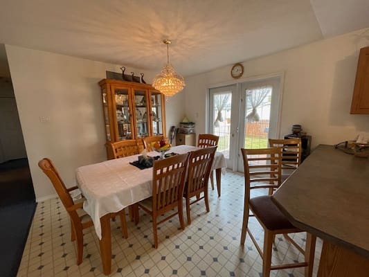 Dining room with wooden table and chairs.