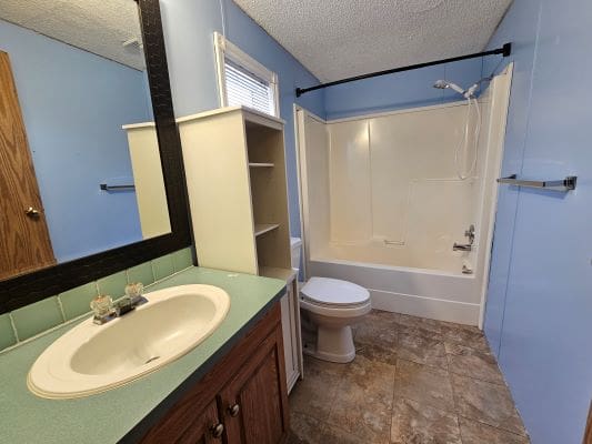 Small bathroom with sink and bathtub.