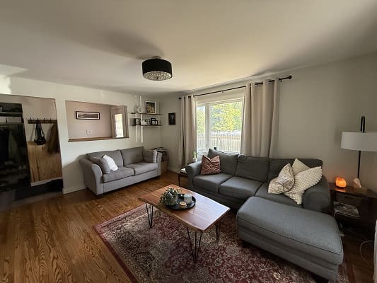 Cozy living room with gray sofas, window.