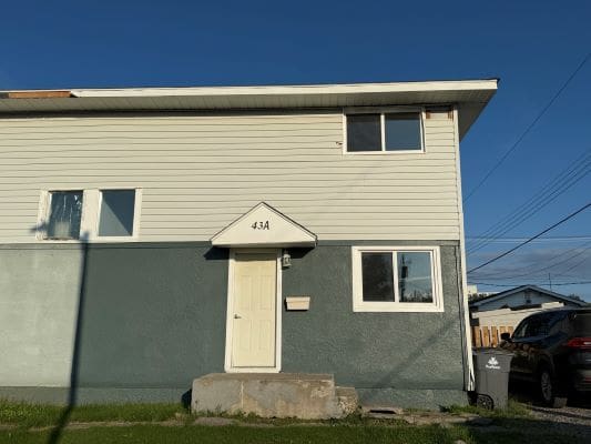 Two-story house with white door.
