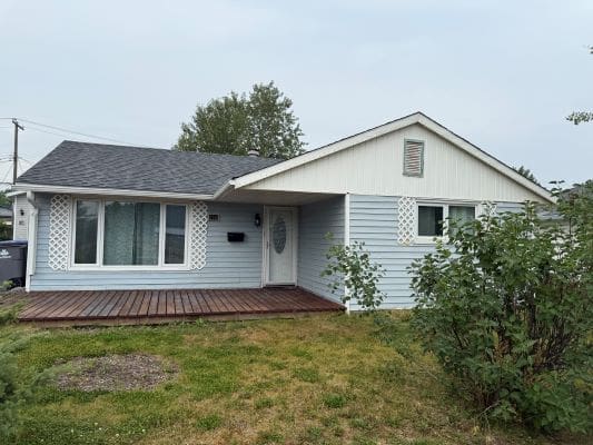 Small blue house with front porch.