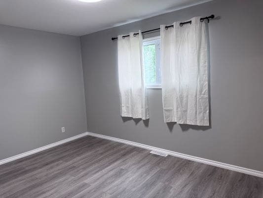 Empty room with gray walls and window.