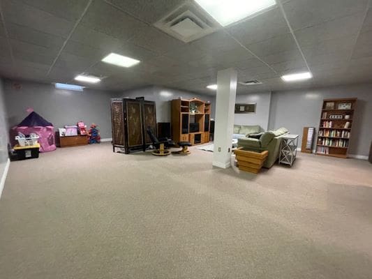 Spacious basement with furniture and storage shelves.