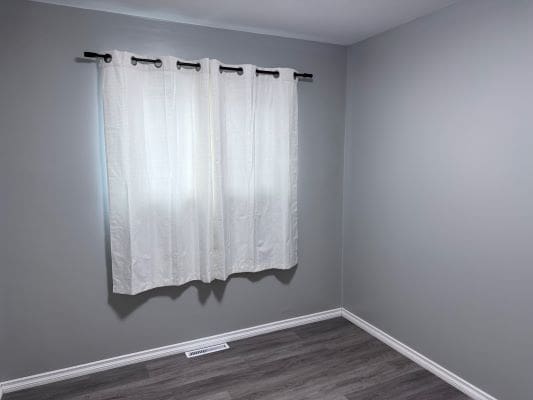 Empty room with gray walls and curtains.