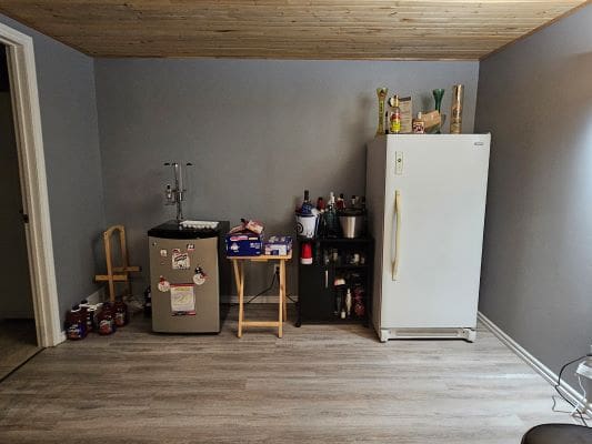 Home bar setup with appliances and supplies.