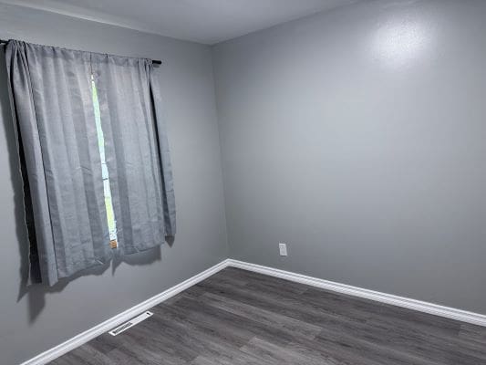 Empty room with gray walls and curtains.