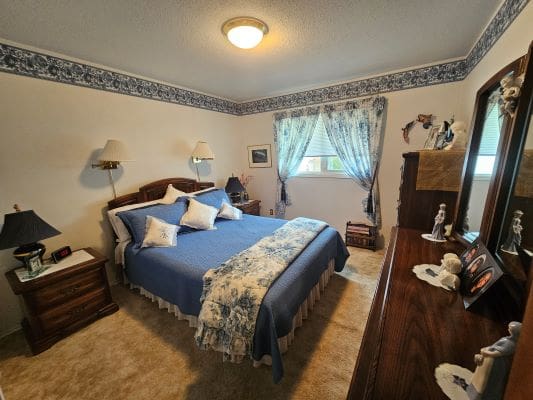 Cozy bedroom with blue and white decor.