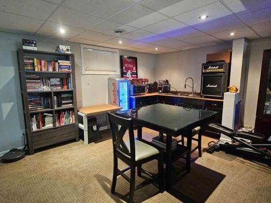 Home office with bookshelves and kitchenette.