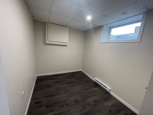 Empty room with dark wood flooring.