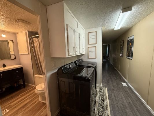 Laundry area in a narrow hallway.