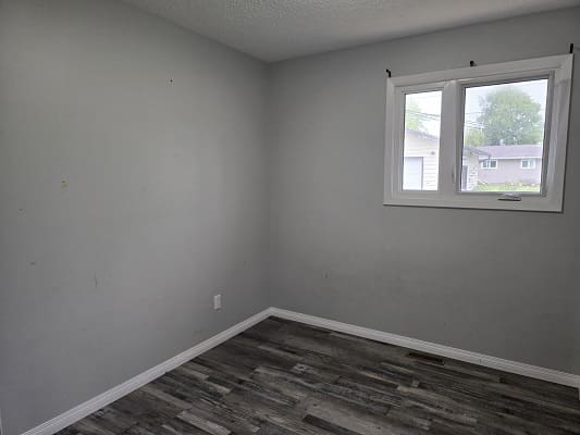Empty room with gray walls and window.