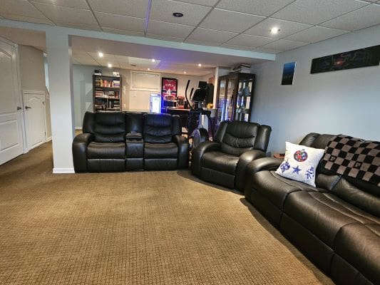 Home theater with leather seating and decor.