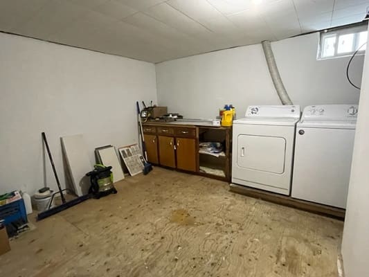 Basement laundry room with washer and dryer.