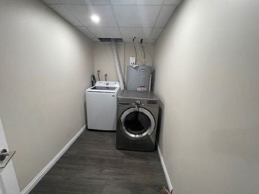 Laundry room with washer and dryer units.