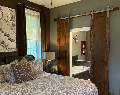 Bedroom with sliding door to bathroom.