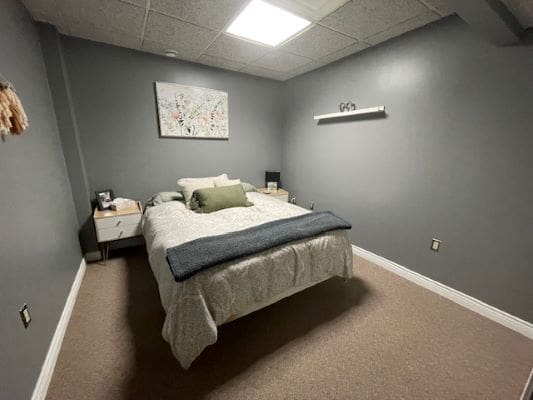 Small, cozy bedroom with gray walls.