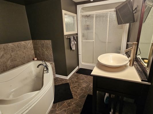 Modern bathroom with tub and shower.