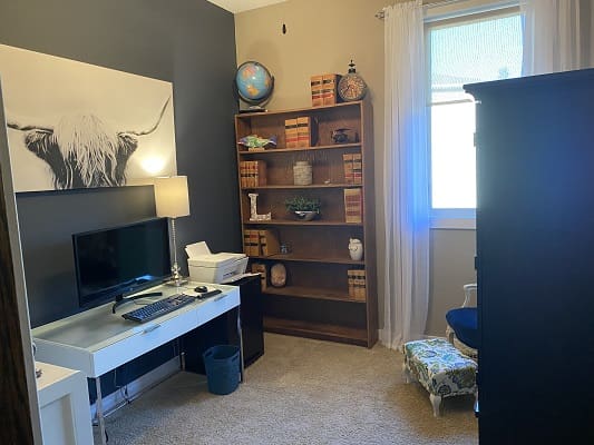 Home office with desk and bookshelf.