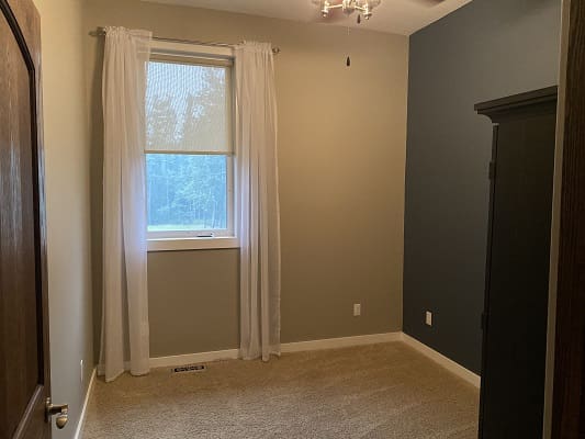 Empty room with window and curtains.