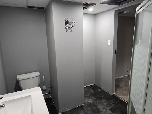 Modern bathroom with toilet and sink.