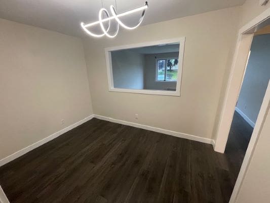 Empty room with wooden floor and window.