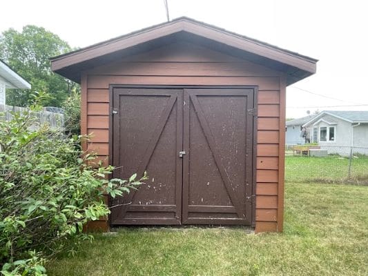 Brown wooden shed with double doors.