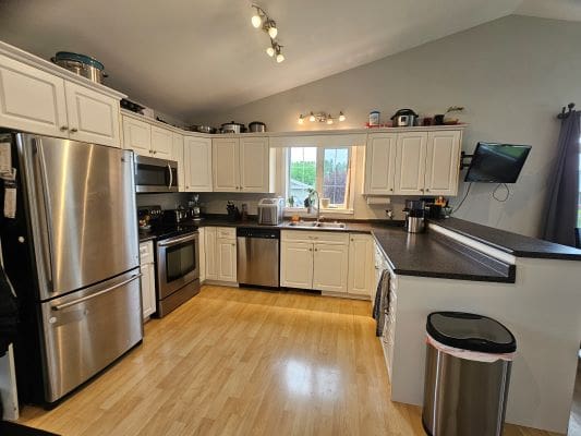 Modern kitchen with stainless steel appliances.