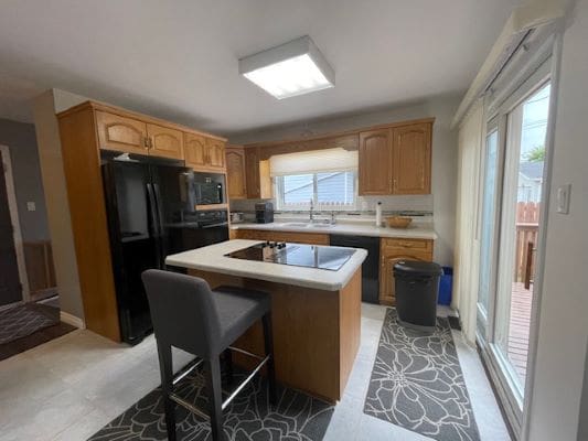 Modern kitchen with island and large window.
