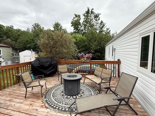 Wooden deck with chairs and fire pit.