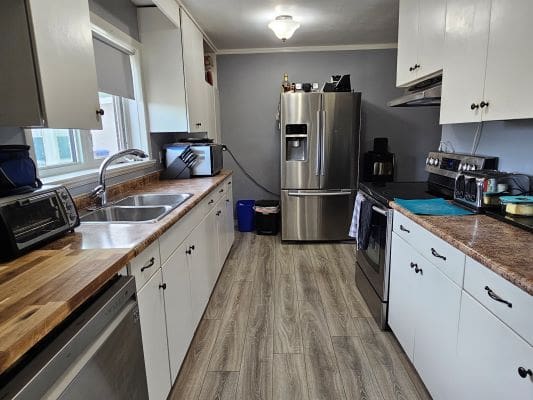 Modern kitchen with stainless steel appliances.