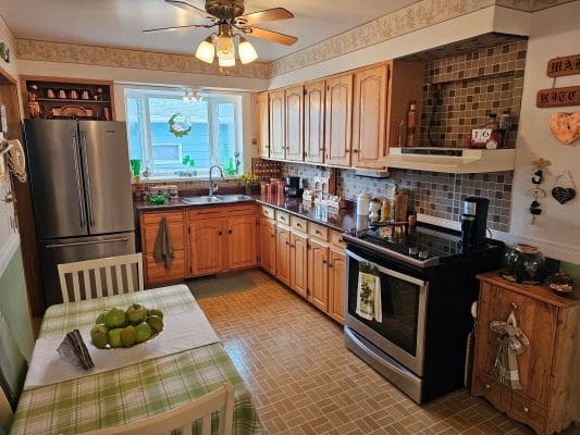 Cozy kitchen with wooden cabinets and table.