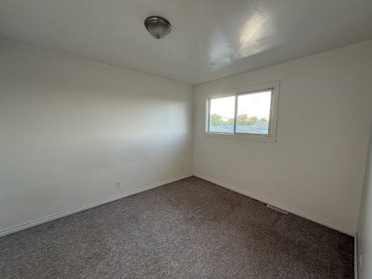 Empty room with carpet and window.