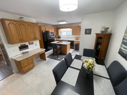 Modern kitchen and dining area with flowers.